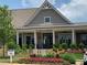Clubhouse at Herrington, a charming community building surrounded by lush landscaping and colorful flowers at 3351 Orwell Way # 2305, Cumming, GA 30041