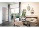 Bright dining area with a glass table, cushioned bench, and balcony access at 3351 Orwell Way # 2305, Cumming, GA 30041