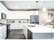 Bright kitchen featuring white cabinets, a large island, and modern stainless steel appliances at 3351 Orwell Way # 2305, Cumming, GA 30041