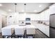 A bright white kitchen with a large island, stainless steel appliances, and modern lighting at 3351 Orwell Way # 2305, Cumming, GA 30041