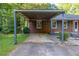 Attached carport featuring a brick wall and a covered parking area at 4370 Tradition Ter, Austell, GA 30106