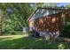 Charming home featuring a side porch, brick facade, and a lush green lawn at 4370 Tradition Ter, Austell, GA 30106