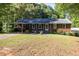 Charming brick home with a well-manicured lawn and covered parking at 4370 Tradition Ter, Austell, GA 30106