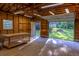 Spacious detached garage interior with open door to a lush green yard, wooden shelving and workbench at 4370 Tradition Ter, Austell, GA 30106