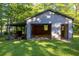 Open detached garage features ample space for storage and projects, with a covered area on the side at 4370 Tradition Ter, Austell, GA 30106