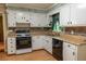 Well-lit kitchen with white cabinetry, laminate countertops, and backsplash at 4370 Tradition Ter, Austell, GA 30106