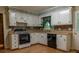 Functional kitchen featuring white cabinetry, laminate countertops, and black appliances at 4370 Tradition Ter, Austell, GA 30106