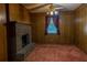 Cozy living room features a brick fireplace and wood-paneled walls, lit by a ceiling fan at 4370 Tradition Ter, Austell, GA 30106