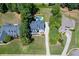 An aerial view shows the property's layout with the sparkling pool, surrounding greenery, and proximity to other homes at 5178 Stefan Ridge Way, Buford, GA 30519