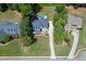An aerial view shows a home with a long driveway, a manicured front yard, and lush landscaping at 5178 Stefan Ridge Way, Buford, GA 30519