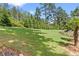 This backyard showcases a huge manicured lawn with mature trees and landscaping, offering a private and serene outdoor space at 5178 Stefan Ridge Way, Buford, GA 30519