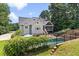 A picturesque backyard showcases a pool, lush greenery, and a charming screened-in porch, all surrounded by a privacy fence at 5178 Stefan Ridge Way, Buford, GA 30519