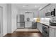 Basement kitchenette features stainless steel appliances and gray cabinets at 5178 Stefan Ridge Way, Buford, GA 30519