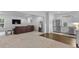 Finished basement featuring a kitchenette, carpeted floor, and a relaxing living area at 5178 Stefan Ridge Way, Buford, GA 30519