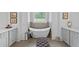 Bathroom featuring a freestanding tub with tiled walls and double sink vanity at 5178 Stefan Ridge Way, Buford, GA 30519