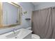 Bathroom with a single sink, tiled shower, and decorative accents at 5178 Stefan Ridge Way, Buford, GA 30519