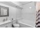 Bright bathroom with a tub and shower combination, tile surround, and vanity at 5178 Stefan Ridge Way, Buford, GA 30519