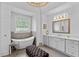 Spa-like bathroom features a freestanding tub, modern vanity, and elegant lighting at 5178 Stefan Ridge Way, Buford, GA 30519