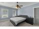 Inviting bedroom with neutral tones, a ceiling fan, and natural light from the windows at 5178 Stefan Ridge Way, Buford, GA 30519