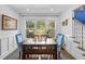 Inviting dining room featuring a large window that provides ample natural light and views of the backyard at 5178 Stefan Ridge Way, Buford, GA 30519