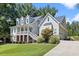 Beautiful two-story home with a manicured lawn and a long driveway leading to an attached garage at 5178 Stefan Ridge Way, Buford, GA 30519