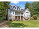 Charming two-story home with a covered front porch,dormer windows, and a well-maintained front yard at 5178 Stefan Ridge Way, Buford, GA 30519