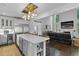 Open-concept kitchen featuring an island with quartz countertops, stainless steel appliances, and modern light fixtures at 5178 Stefan Ridge Way, Buford, GA 30519
