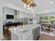 Open concept kitchen with a large island, stainless appliances and breakfast bar that opens to the living room at 5178 Stefan Ridge Way, Buford, GA 30519