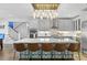 Eat-in kitchen with island, quartz countertops, stainless steel appliances and view to stairway at 5178 Stefan Ridge Way, Buford, GA 30519