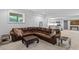 Spacious living room with a large leather couch and view into the kitchen area at 5178 Stefan Ridge Way, Buford, GA 30519