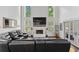 Living room with cathedral ceiling, large windows, painted brick fireplace and sectional sofa at 5178 Stefan Ridge Way, Buford, GA 30519