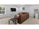 Cozy living room featuring a large leather couch and modern entertainment center at 5178 Stefan Ridge Way, Buford, GA 30519