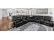 Open concept living room and kitchen features a large sectional sofa, custom rug and breakfast bar at 5178 Stefan Ridge Way, Buford, GA 30519