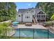 This backyard features a sparkling pool, a lounge area, patio seating, and a screened-in porch, perfect for outdoor living at 5178 Stefan Ridge Way, Buford, GA 30519