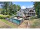 Backyard view featuring a sparkling pool, lounge area, patio seating, fenced yard, and screened-in porch perfect for relaxation at 5178 Stefan Ridge Way, Buford, GA 30519