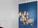 Stylish lighting fixture against a blue accent wall with a large world map at 5178 Stefan Ridge Way, Buford, GA 30519