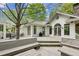 Wide deck with built-in seating areas, accessible from the home's French doors, perfect for outdoor living at 5251 Powers Ferry Rd, Atlanta, GA 30327