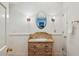 Bathroom features a wooden vanity with drawers, vintage mirror, and sconces at 5251 Powers Ferry Rd, Atlanta, GA 30327