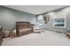 Bedroom with crib, chair, neutral tones, and window at 5251 Powers Ferry Rd, Atlanta, GA 30327