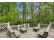 Spacious deck with multiple built-in benches overlooking a wooded area, ideal for gatherings and enjoying nature at 5251 Powers Ferry Rd, Atlanta, GA 30327
