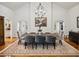 Formal dining room featuring a stylish chandelier, large table, and hardwood floors at 5251 Powers Ferry Rd, Atlanta, GA 30327