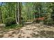Wide driveway, surrounded by mature trees and flowering bushes at 5251 Powers Ferry Rd, Atlanta, GA 30327