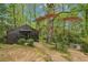 Wood-sided home nestled in a lush, green wooded lot offering privacy and a natural setting at 5251 Powers Ferry Rd, Atlanta, GA 30327