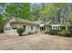 Charming home featuring a spacious driveway, two-car garage and an inviting pergola-covered entrance at 5251 Powers Ferry Rd, Atlanta, GA 30327