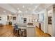 Open-concept kitchen featuring custom cabinets, stainless steel appliances, and hardwood floors at 5251 Powers Ferry Rd, Atlanta, GA 30327