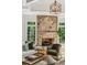 Warm living room showcasing a stone fireplace, well-lit with natural light at 5251 Powers Ferry Rd, Atlanta, GA 30327