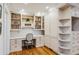 Home office with custom built-in shelving and storage cabinetry at 5251 Powers Ferry Rd, Atlanta, GA 30327