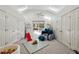 Spacious playroom with vaulted ceiling, skylights, multiple closets, and colorful toys at 5251 Powers Ferry Rd, Atlanta, GA 30327