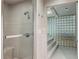 Modern shower with glass door, built-in seat and niche, and tile surround at 5251 Powers Ferry Rd, Atlanta, GA 30327