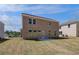 Two-story home backyard with green grass and patio area at 623 Leafy Branch Way, Mcdonough, GA 30253